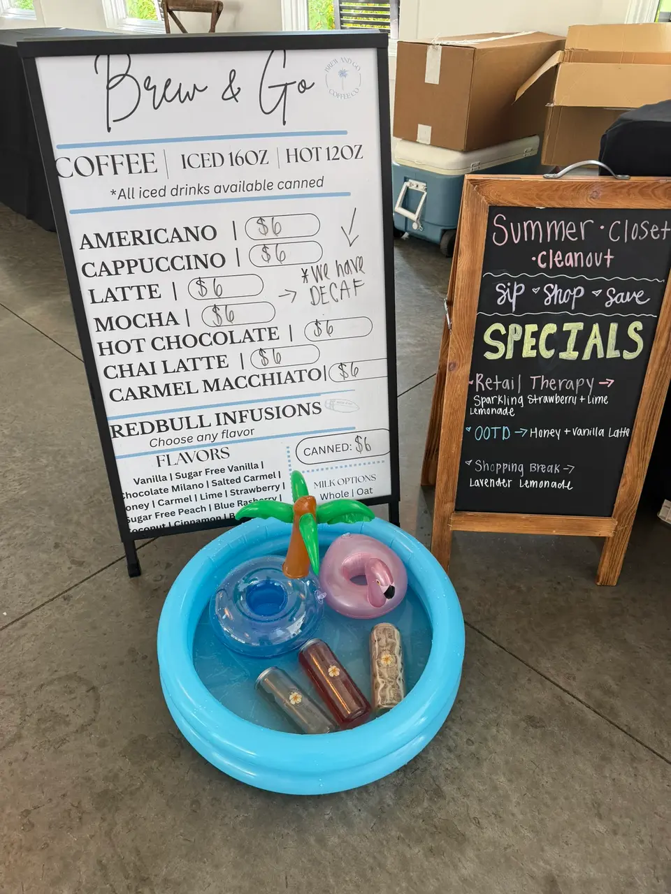 Her menu board next to a specials chalkboard and the kiddie pool of cans